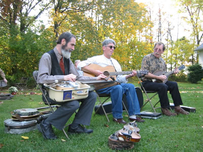 The Lonesome Moonlight Trio playing bluegrass in the yard